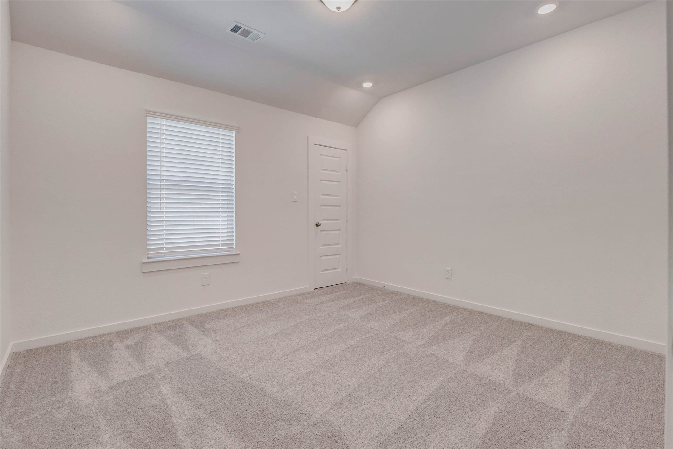 1038 Elsinore Drive Rosharon, TX 77583 - Photo 15 of 27 A comfortable secondary bedroom offers a bright and versatile space ideal for family members, guests, or a home office. Plush carpeting, soft neutral tones, and a large window create a relaxing atmosphere filled with natural light. The room provides ample wall space and flexibility for furniture placement, making it easy to customize the space to fit your needs.