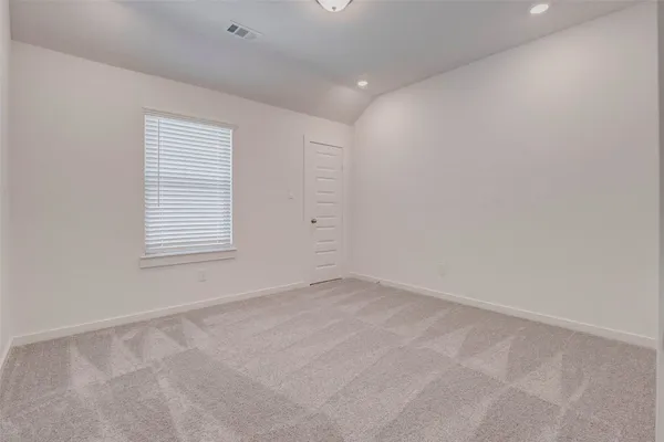 an empty room with closet and windows