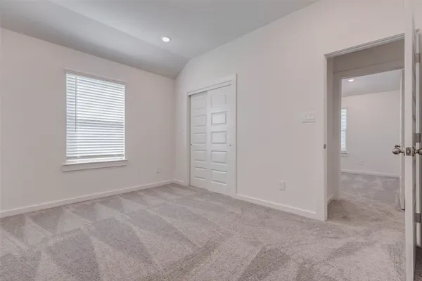 an empty room with closet and bathroom
