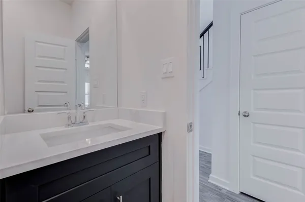 a view of a house with a yard potted plants and a bench