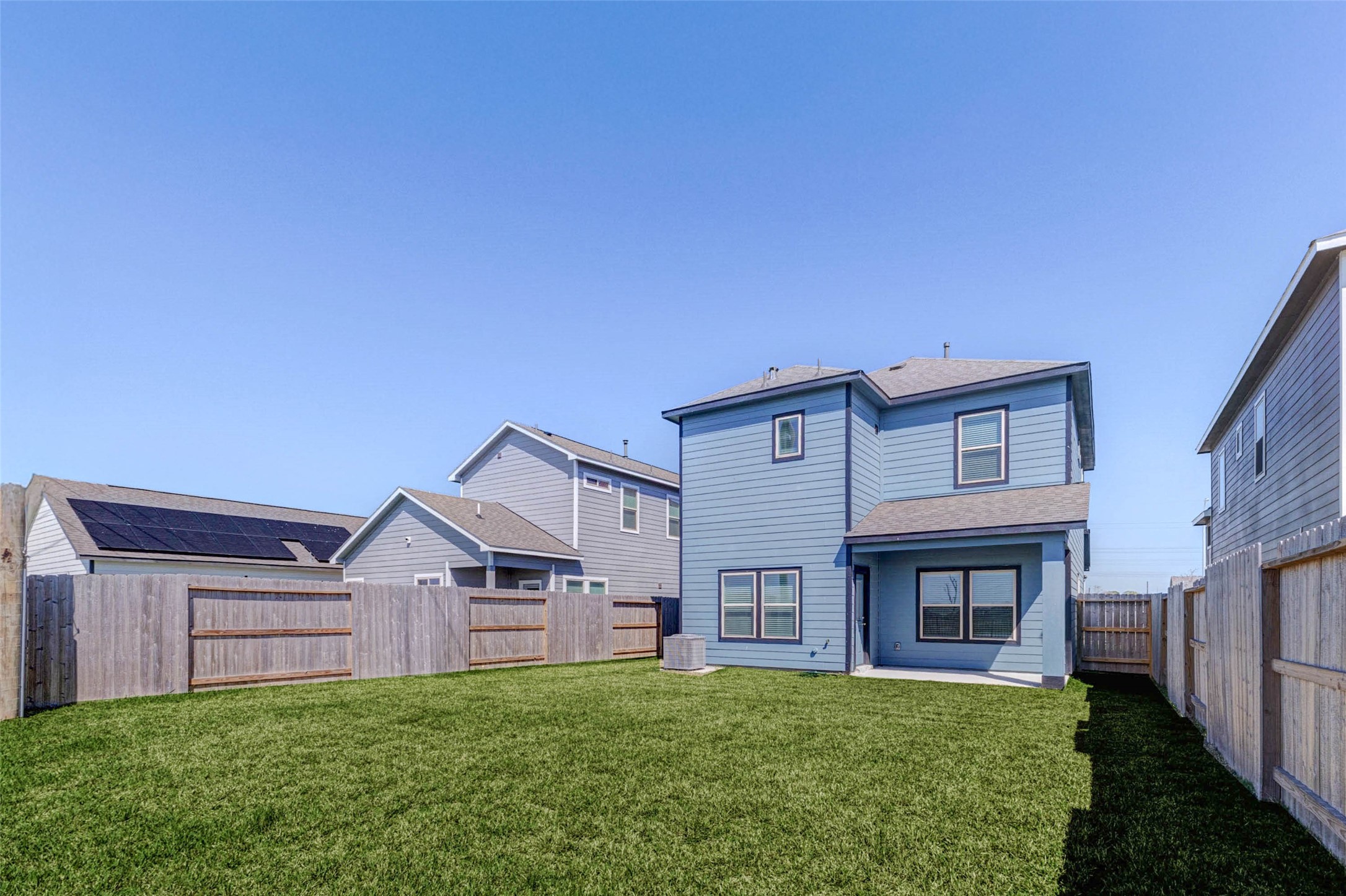 1038 Elsinore Drive Rosharon, TX 77583 - Photo 22 of 27 A clean and modern bathroom vanity area features a sleek quartz countertop, contemporary chrome fixtures, and a large mirror that enhances the sense of space and brightness. The dark cabinetry provides striking contrast against the light surfaces while offering convenient storage. Positioned just outside the bathroom area, this layout adds functionality and convenience for daily routines and shared use.
