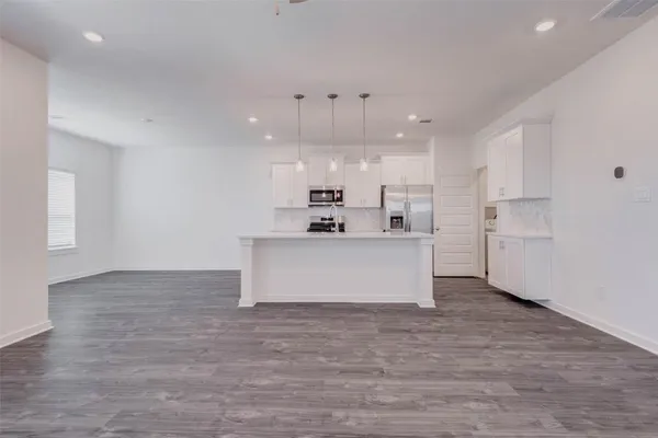 a view of kitchen with cabinets and wooden floor