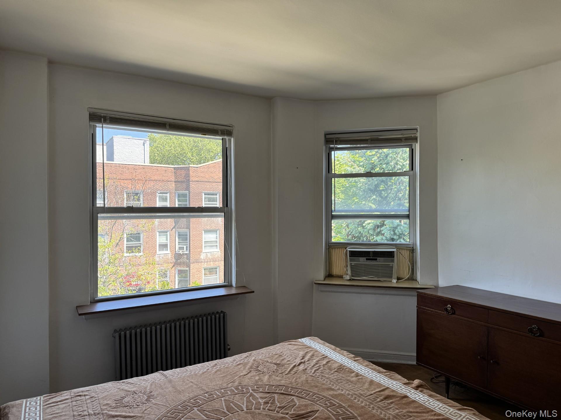 141-24 78th Road, Unit 3A Queens, NY 11367 - Photo 8 of 18 a bedroom with a bed window and a window