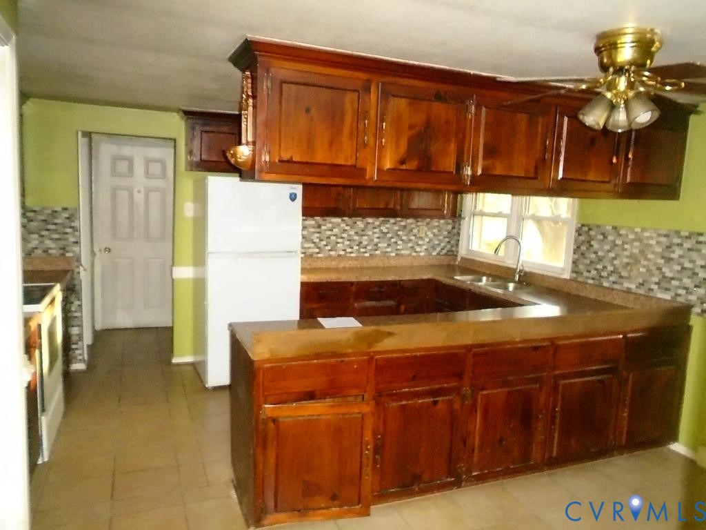16203 West Patrick Henry Road Montpelier, VA 23192 - Photo 13 of 23 Kitchen featuring wood cabinetry, tiled flooring,