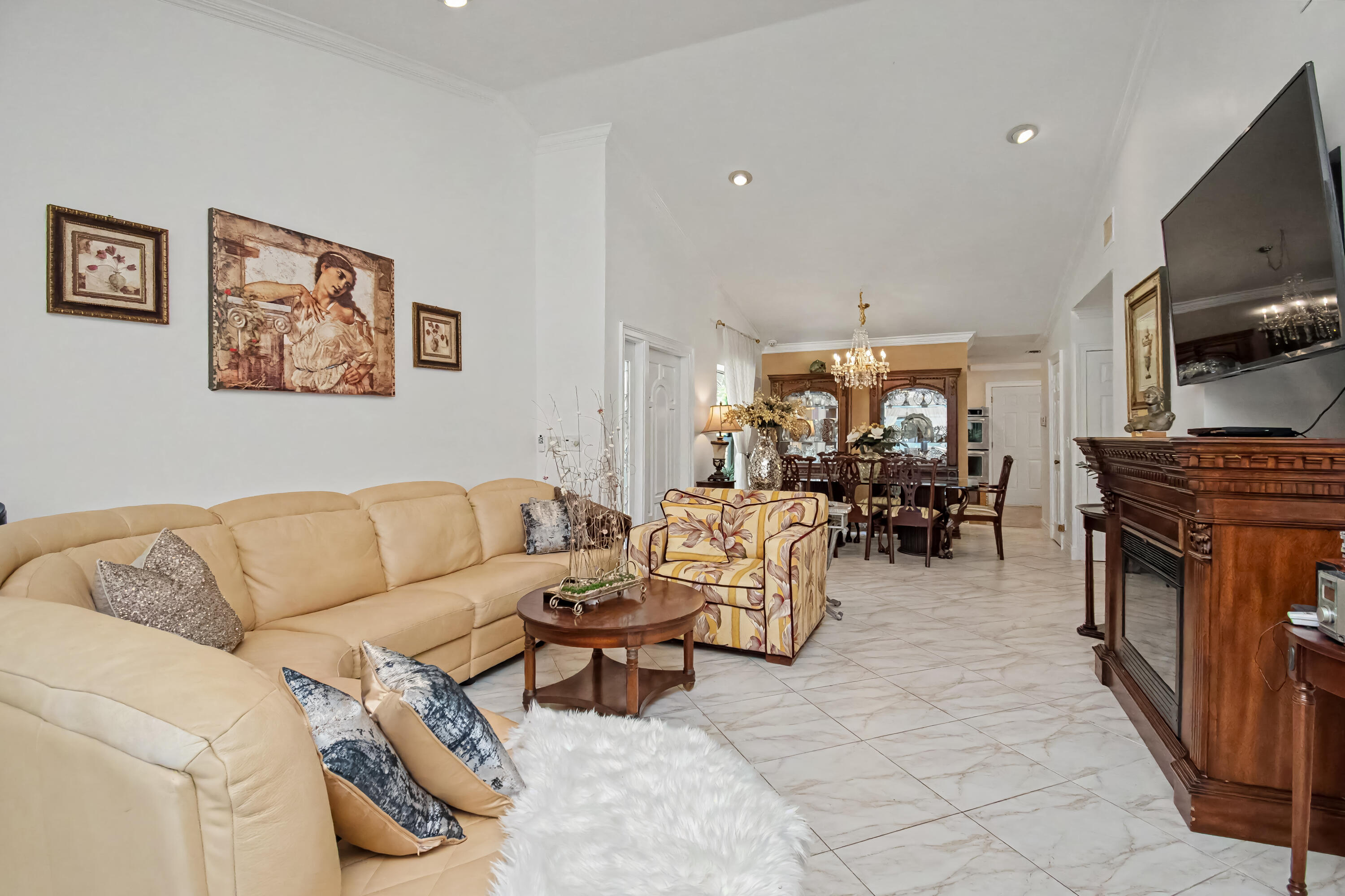 9708 Erica Court Boca Raton, FL 33496 - Photo 14 of 54 a living room with furniture flat screen tv and a fireplace