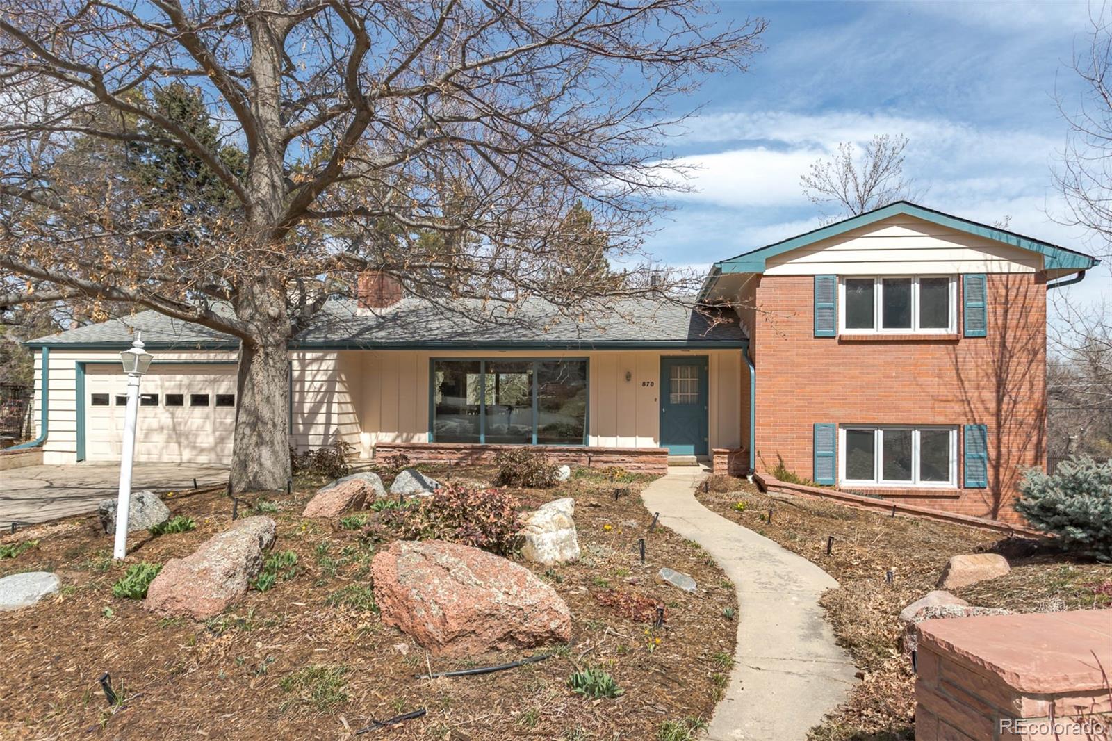 870 Willowbrook Road Boulder, CO 80302 - Photo 1 of 30 a front view of a house with a yard covered with snow in the background