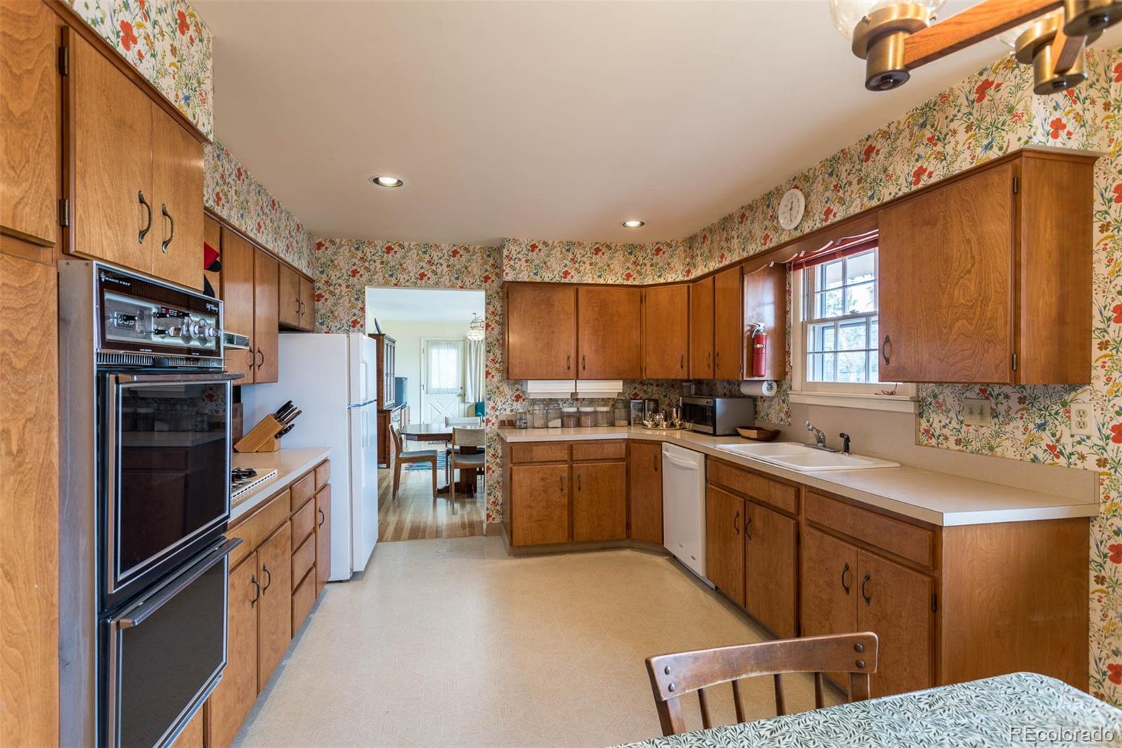 870 Willowbrook Road Boulder, CO 80302 - Photo 8 of 30 a kitchen with a sink refrigerator and cabinets