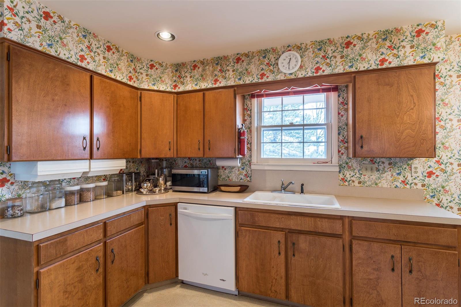 870 Willowbrook Road Boulder, CO 80302 - Photo 9 of 30 a kitchen with a sink window and cabinets