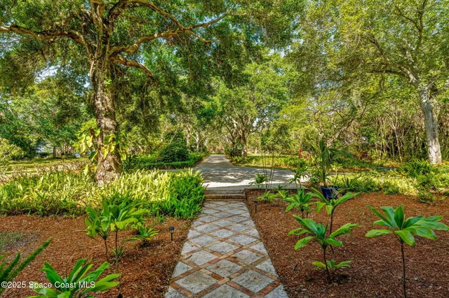 a living room with furniture a rug and a chandelier