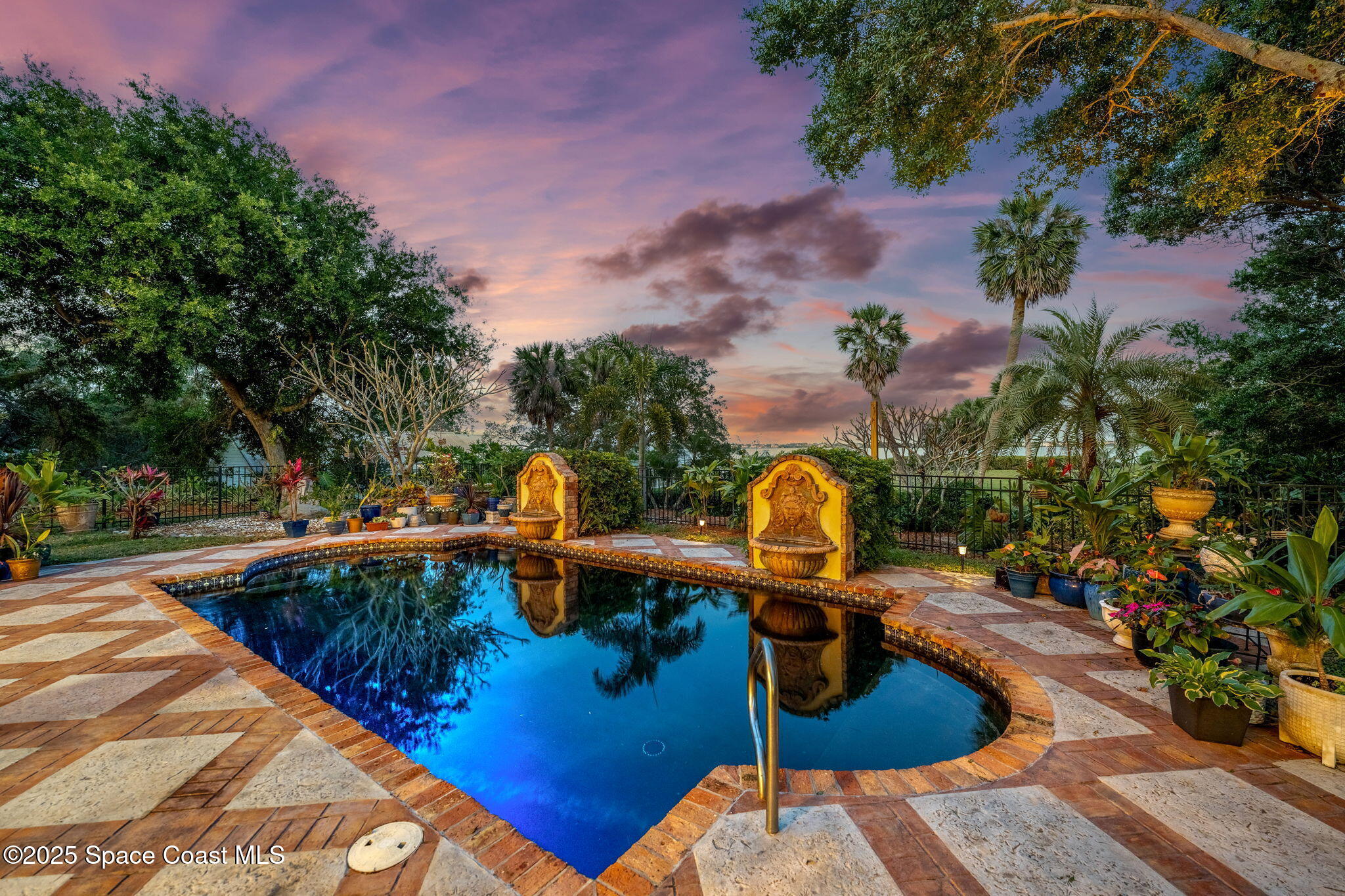 9340 South Tropical Trail Merritt Island, FL 32952 - Photo 2 of 100 a view of a swimming pool with a patio