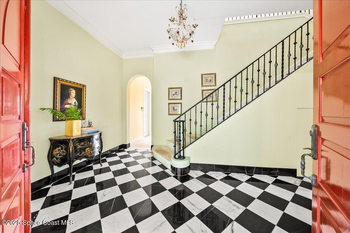 9340 South Tropical Trail Merritt Island, FL 32952 - Photo 21 of 100 a view of a entryway with a checkered floor and a rug