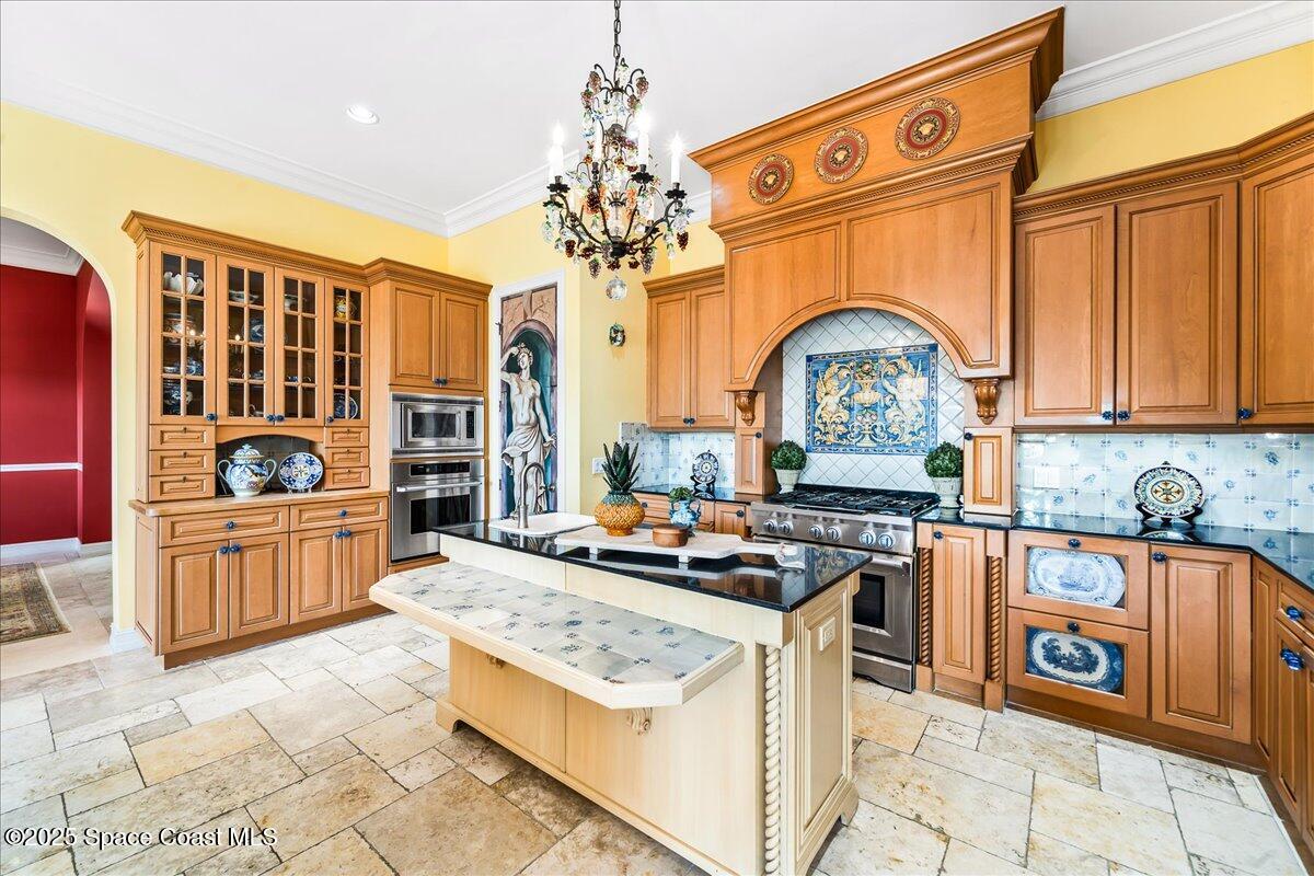 9340 South Tropical Trail Merritt Island, FL 32952 - Photo 22 of 100 a kitchen with stainless steel appliances granite countertop a stove a sink dishwasher and cabinets with wooden floor