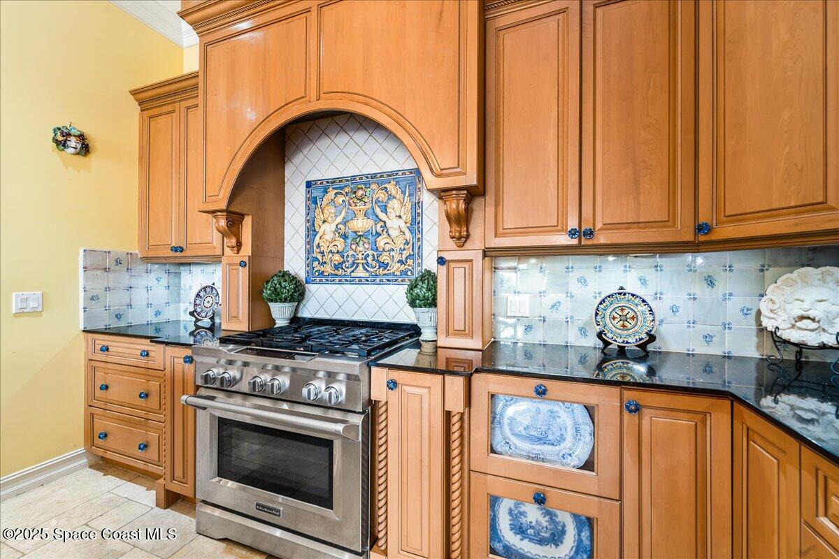 9340 South Tropical Trail Merritt Island, FL 32952 - Photo 24 of 100 a kitchen with stainless steel appliances granite countertop a stove and cabinets