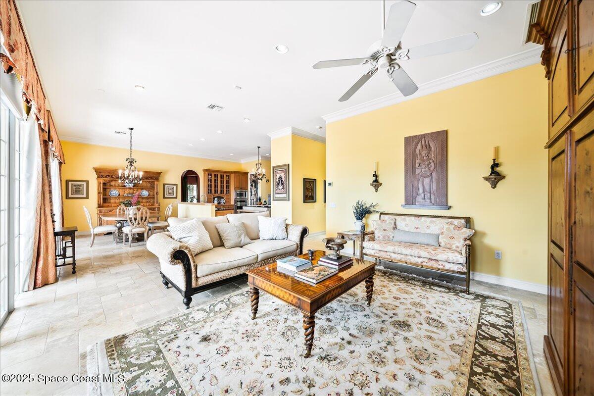 9340 South Tropical Trail Merritt Island, FL 32952 - Photo 30 of 100 a living room with furniture a rug and a chandelier