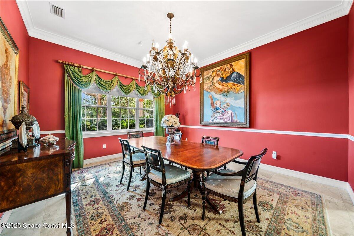9340 South Tropical Trail Merritt Island, FL 32952 - Photo 36 of 100 a dining room with furniture a large window and a chandelier