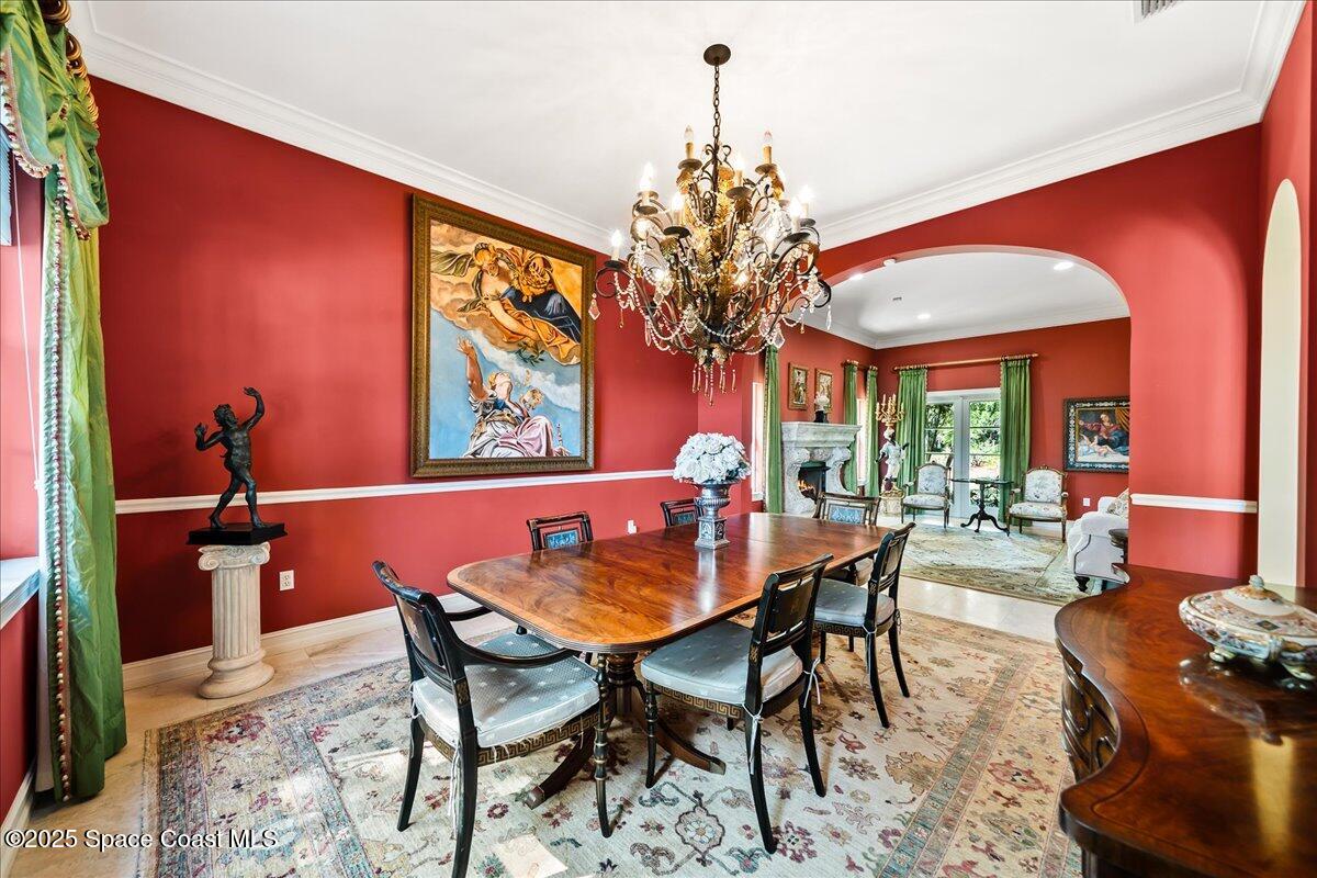 9340 South Tropical Trail Merritt Island, FL 32952 - Photo 37 of 100 a view of a dining room with furniture a chandelier and wooden floor