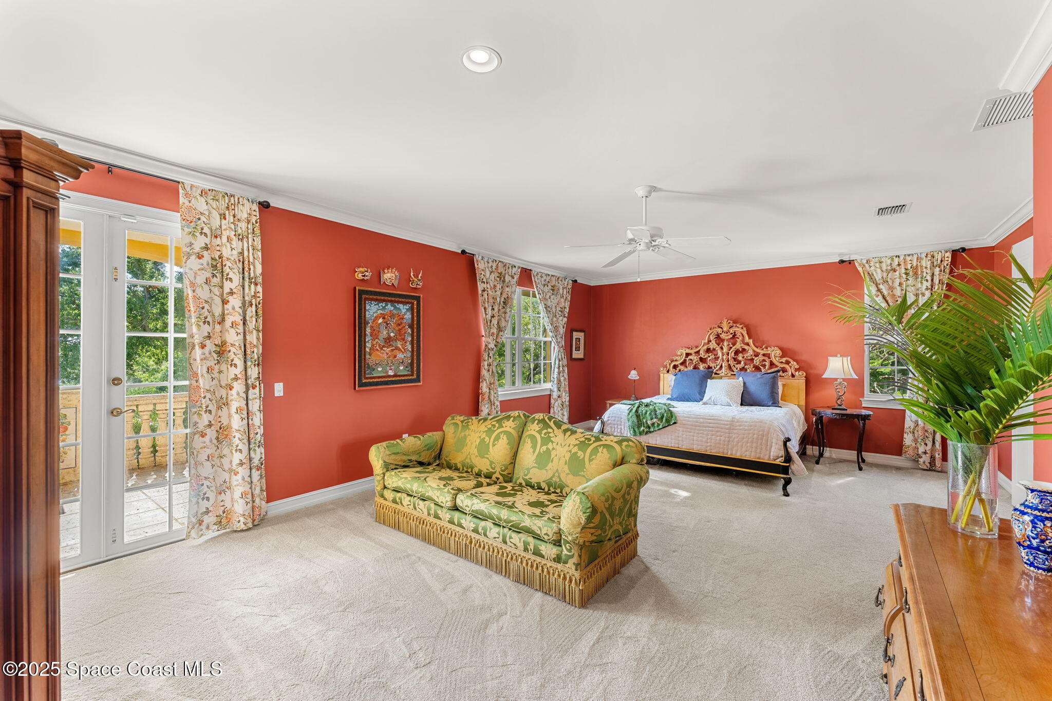 9340 South Tropical Trail Merritt Island, FL 32952 - Photo 39 of 100 a bedroom with furniture and a potted plant