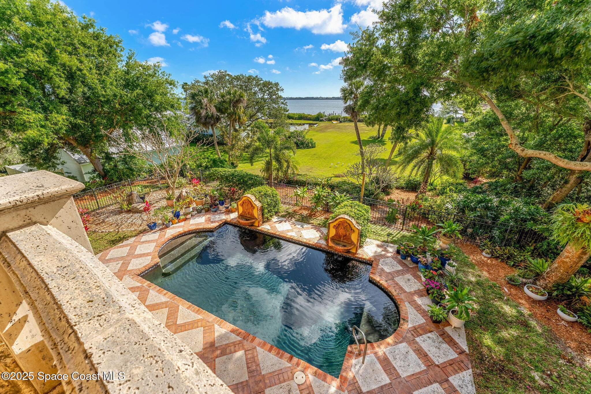 9340 South Tropical Trail Merritt Island, FL 32952 - Photo 49 of 100 a view of a swimming pool with a patio and a yard