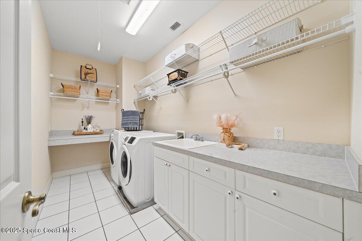 9340 South Tropical Trail Merritt Island, FL 32952 - Photo 55 of 100 a kitchen with a sink cabinets and appliances