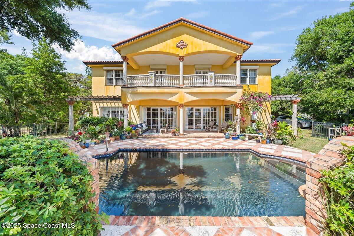 9340 South Tropical Trail Merritt Island, FL 32952 - Photo 56 of 100 a view of a house with swimming pool and sitting area