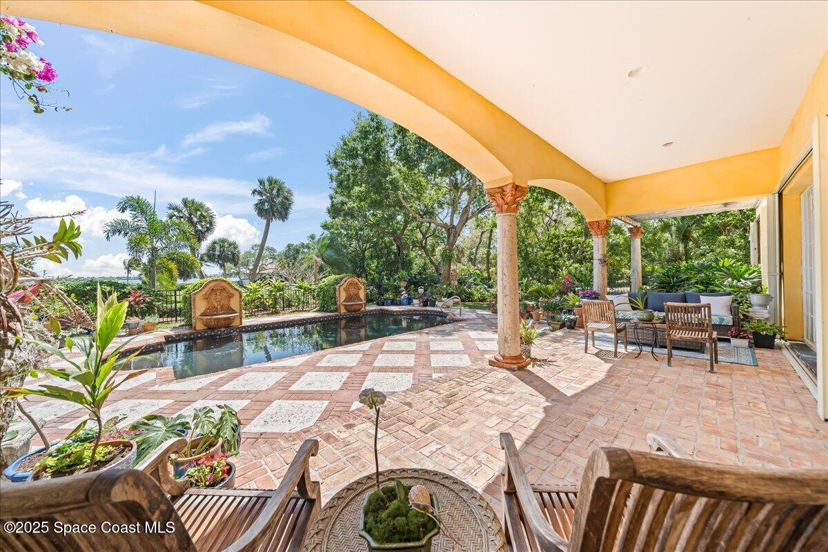 9340 South Tropical Trail Merritt Island, FL 32952 - Photo 63 of 100 a view of an outdoor sitting area with furniture