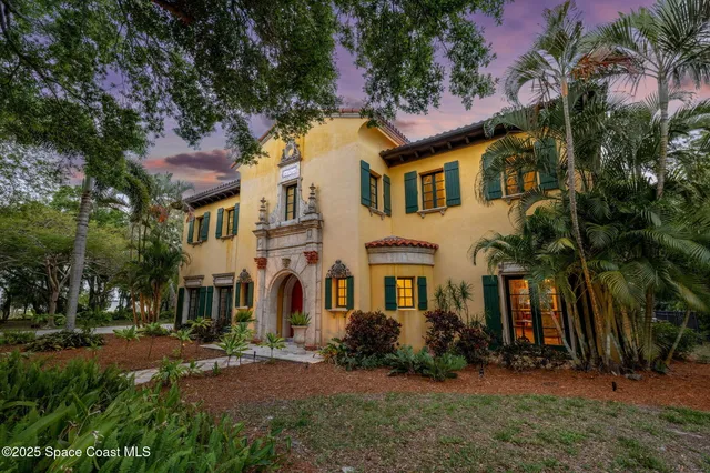 a kitchen with stainless steel appliances granite countertop a stove top oven a refrigerator and a chandelier