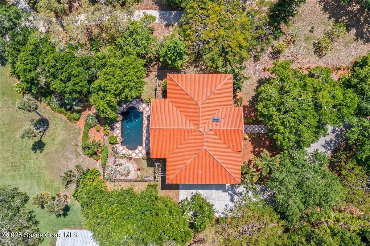9340 South Tropical Trail Merritt Island, FL 32952 - Photo 88 of 100 an aerial view of a house with swimming pool and garden space