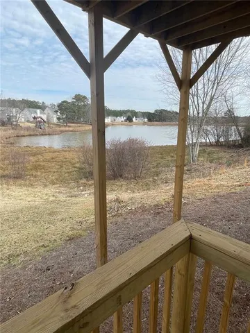 a backyard of a house with a yard and outdoor seating