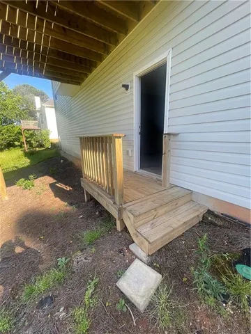 a view of staircase with white walls and white door
