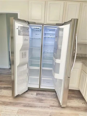 an empty room with wooden floor and closet