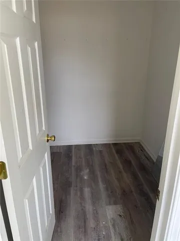 a kitchen with stainless steel appliances granite countertop a refrigerator a stove and a sink with wooden floors