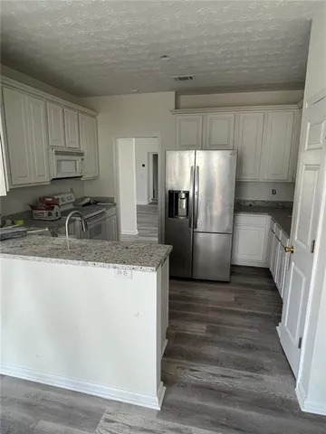 a view of a closet area with wooden floor
