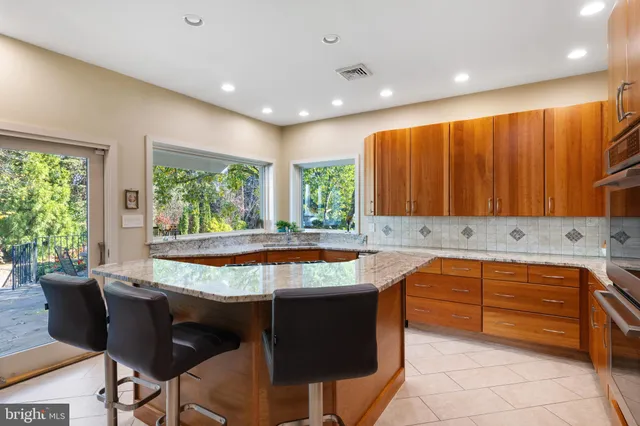 a kitchen with stainless steel appliances granite countertop a sink stove and cabinets