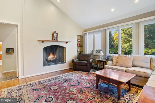 a view of a hallway with furniture and windows