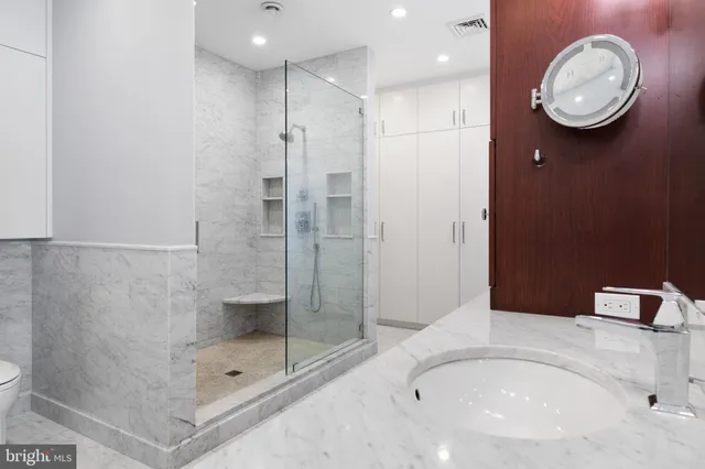 a bed room with a bed and a chair