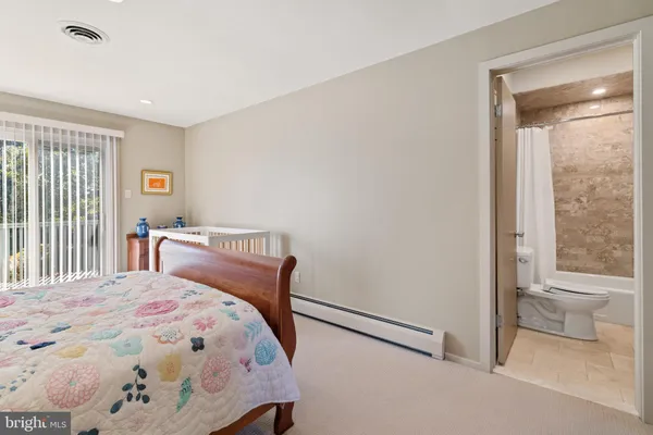 a bedroom with a bed and a lamp