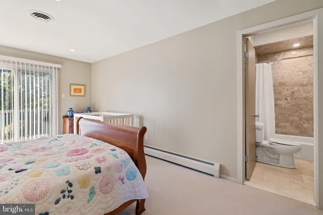 a bedroom with a bed and a lamp