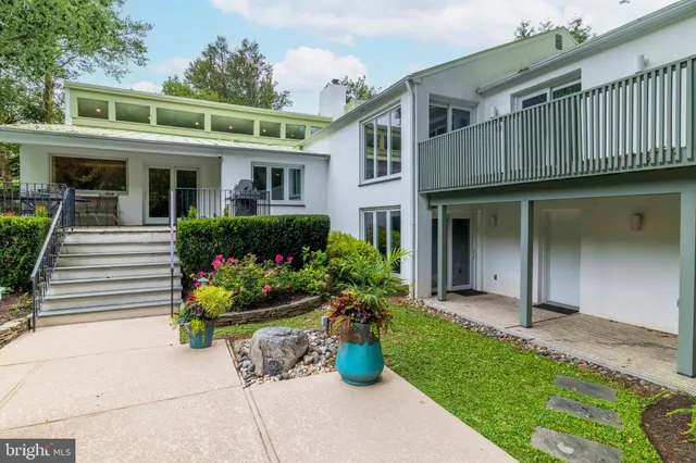 a view of a chairs and table in the back yard of the house