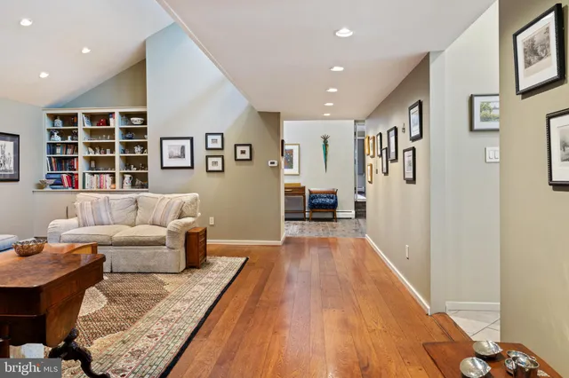 a living room with furniture stairs and a window