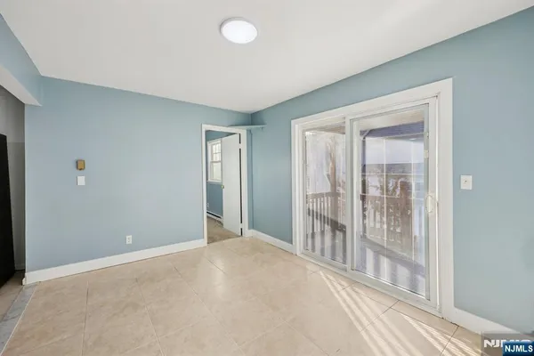 a view of an empty room with glass door