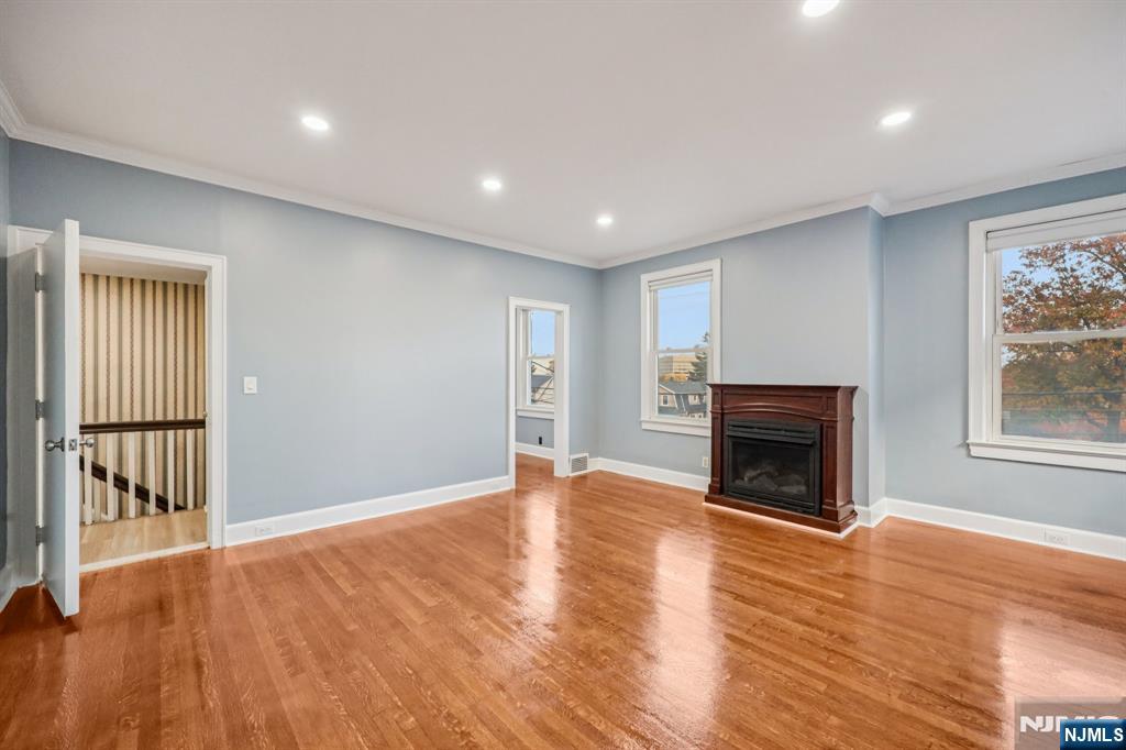 320 Orient Way, Unit 2 Rutherford, NJ 07070 - Photo 15 of 40 a view of empty room with wooden floor and fireplace