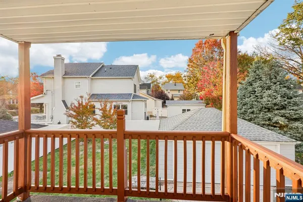 a view of a balcony with wooden fence