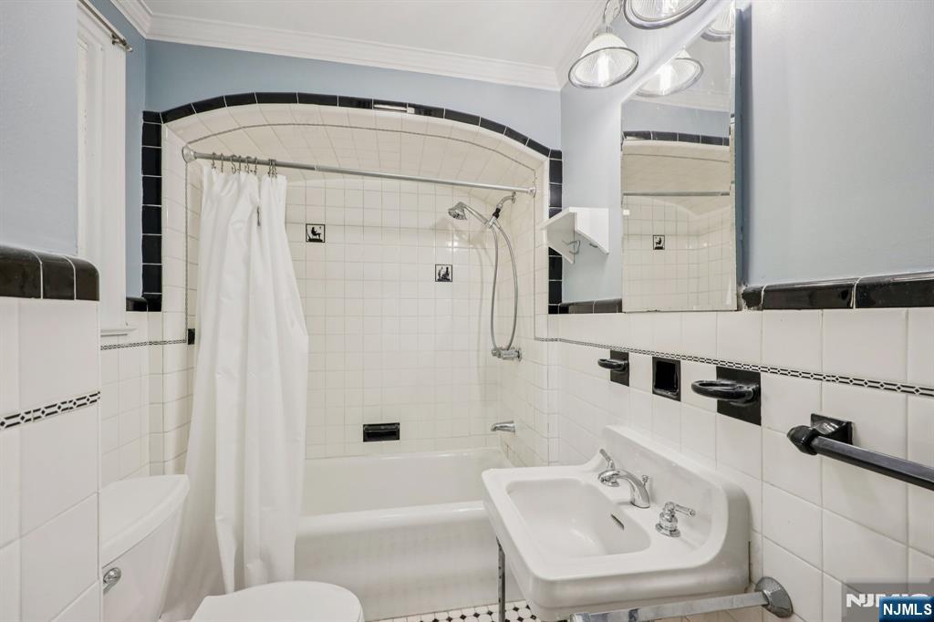 320 Orient Way, Unit 2 Rutherford, NJ 07070 - Photo 23 of 40 a bathroom with a tub sink and mirror
