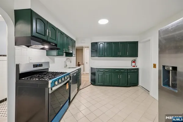 a kitchen with stainless steel appliances granite countertop a stove and a refrigerator