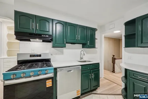 a kitchen with cabinets a stove and a refrigerator