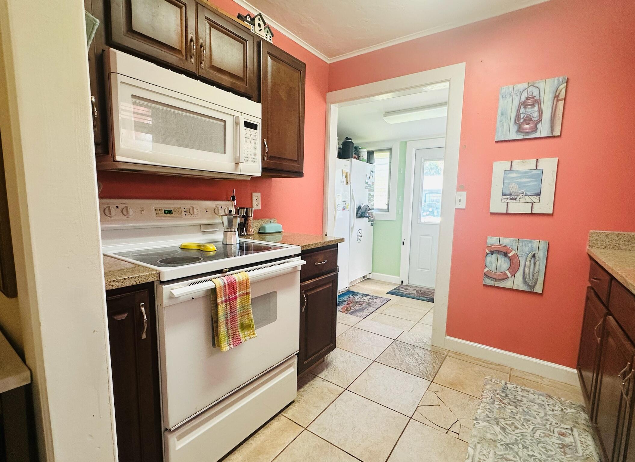2500 Harris Avenue Key West, FL 33040 - Photo 12 of 22 a kitchen with stainless steel appliances granite countertop a sink and a stove top oven