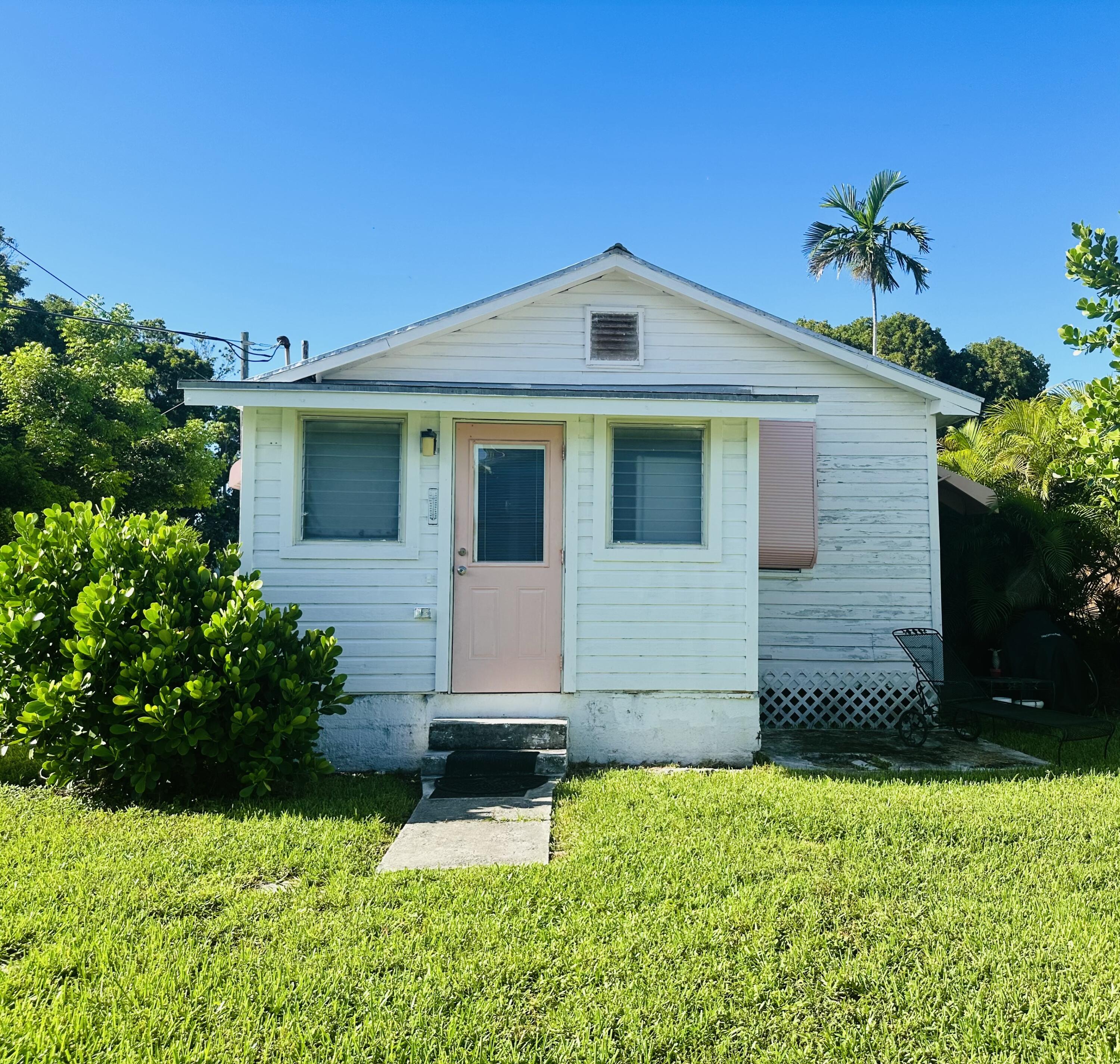 2500 Harris Avenue Key West, FL 33040 - Photo 3 of 22 a front view of a house with a yard