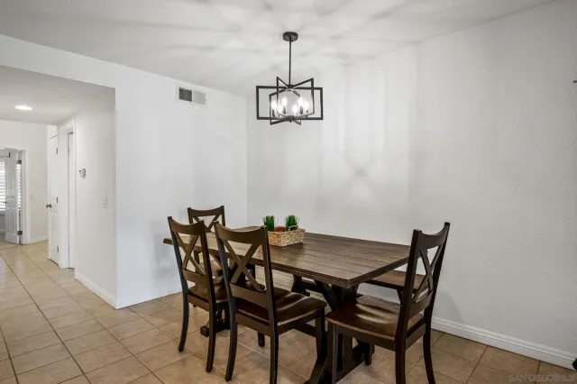 a view of a dining room with furniture wooden floor and a chandelier