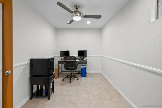 a view of a workspace with furniture and a window
