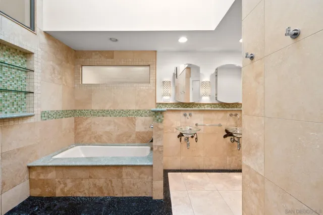 a bathroom with a bathtub and shower